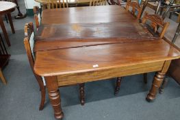 A Victorian mahogany extending dining table with leaf and four dining chairs,