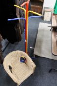 A multi coloured hat and coat stand together with a small child's chair