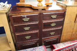 An Edwardian mahogany six drawer chest with cupboard base