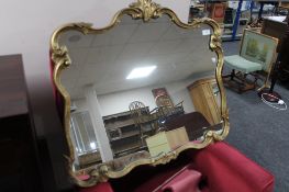 A gilt framed ornate mirror