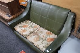 A mid century green vinyl two seater settee