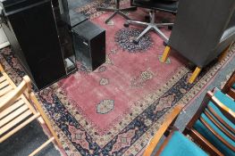 An antique fringed eastern carpet