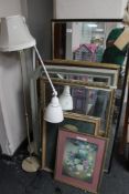 Two floor lamps together with pictures and mirrors