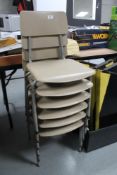 A stack of six mid century school chairs