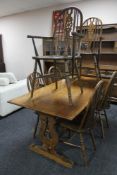 An oak refectory style dining room table together with a set of six Windsor style chairs