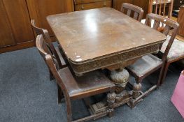 An early twentieth century carved oak table and four chairs