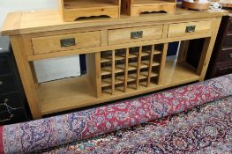 A contemporary light oak kitchen sideboard with bottle rack CONDITION REPORT: 180cm