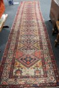 An antique Persian runner CONDITION REPORT: 487cm by 112cm.