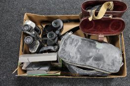 A box of binoculars, cameras,