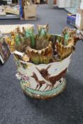 An encrusted potter planter decorated with fawns etc