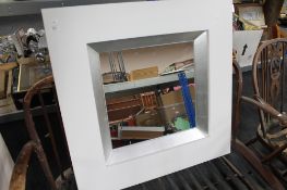 A white contemporary framed mirror CONDITION REPORT: This is 89cm by 89cm by 7.