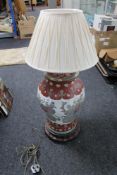 A Chinese table lamp on wooden stand