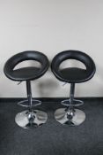 A pair of contemporary gas lift bar stools