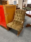 An upholstered brown dralon rocking chair