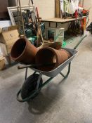 A wheel barrow containing garden planter,