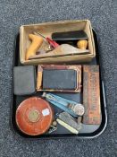 A tray of Chapman woodworking plane, vintage leather tape measure, pocket knives,