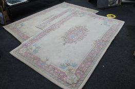 Three floral oriental rugs on cream ground