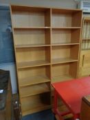A set of teak effect open bookshelves