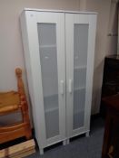 A pair of Ikea white sentry door cabinets