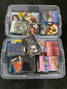 Two plastic storage crates with lids containing DVD's,