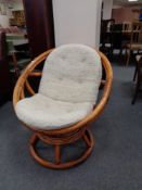 A bamboo and wicker swivel tub chair