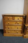 A contemporary pine five drawer chest