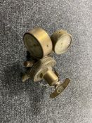 A vintage brass British Oxygen Company valve with two mounted pressure gauges