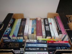 A box of hardback and paperback books;