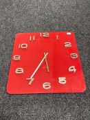 A red glass Karlsson battery operated wall clock