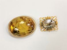 A gilt metal brooch modelled with a pheasent together with a further galleon brooch.