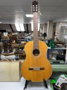 An Ibanez GA30 classical guitar on stand