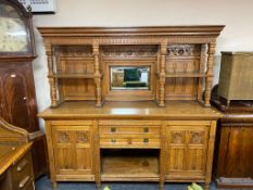 An Edwardian carved oak mirrored sideboard
