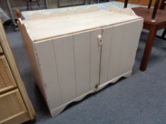 A painted double door cupboard