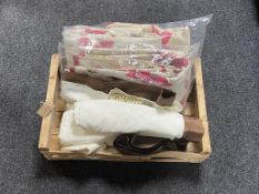 A wooden crate of two pairs of curtains