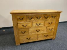 A contemporary oak thirteen drawer chest