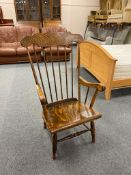A beech spindle back kitchen armchair