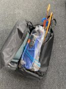 A holdall containing assorted walking sticks, umbrellas,