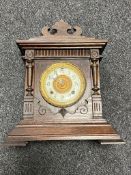 An antique American 8 day mantel clock by The Ansonia Clock Company with pendulum and key