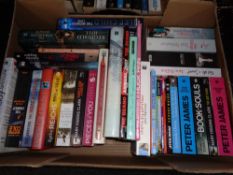 A box of hardback and paperback books; novels including Peter James,