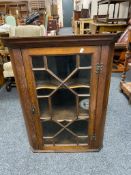 A Georgian oak hanging corner cabinet with astragal glazed door