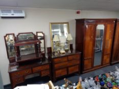 An Edwardian mahogany three piece bedroom suite - triple door wardrobe,