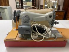A cased Jones electric sewing machine