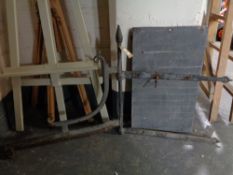 An antique cast iron sign bracket together with a slate shove half penny board