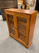 An oak leaded glass door bookcase