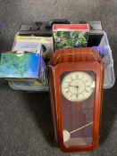 A plastic storage crate with lid containing a battery wall clock leather brief case, socket set,