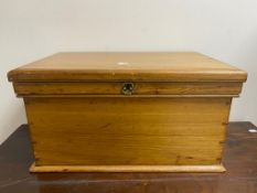 A pine storage box containing a quantity of dvds