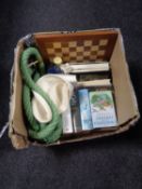 A box of hardbacked books, novels, length of rope, chess board,