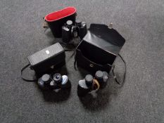 A tray of three sets of cased binoculars,