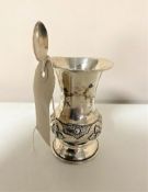 A silver embossed presentation vase together with a continental silver tea spoon