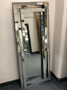 A contemporary rectangular all glass abstract mirror